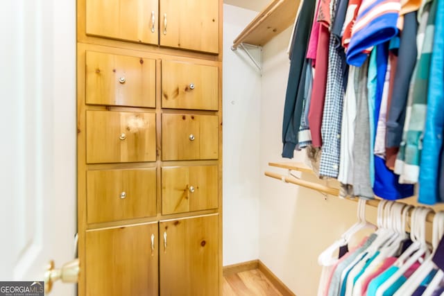 walk in closet featuring light wood-style flooring