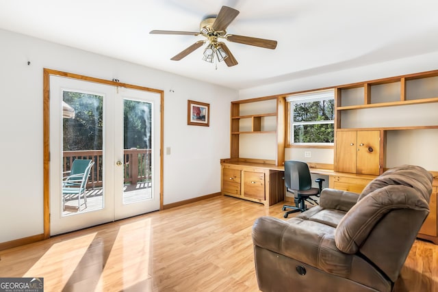office featuring light wood finished floors, french doors, built in desk, and baseboards
