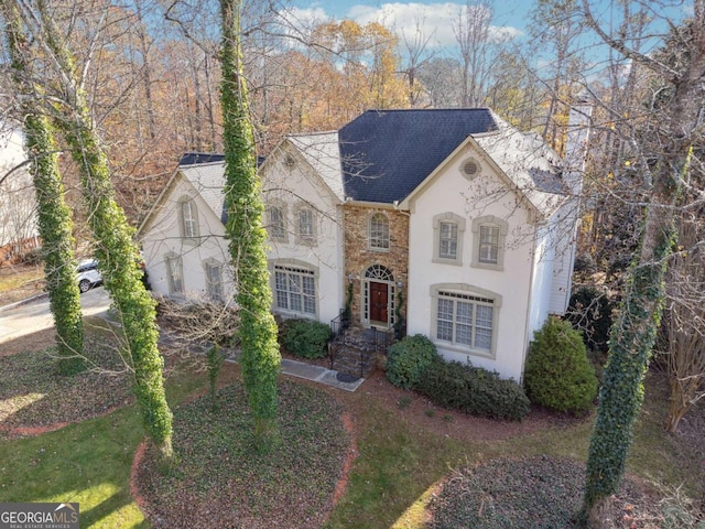 760 Woodrow Dr, Lawrenceville, GA 30043 - view of front facade with a shingled roof, stone siding, and stucco siding