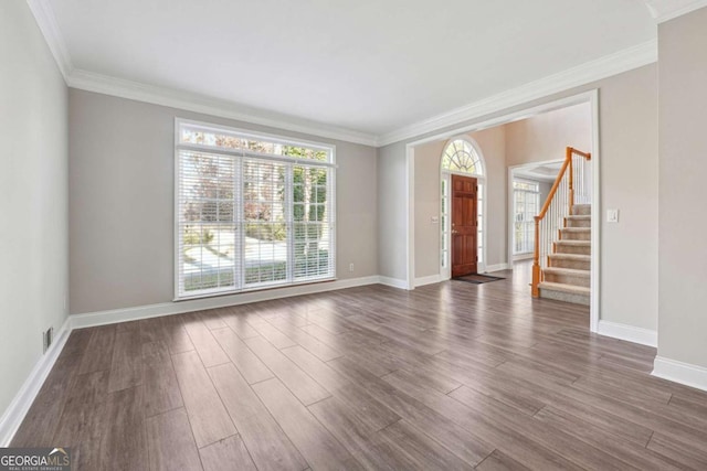 760 Woodrow Dr, Lawrenceville, GA 30043 - unfurnished living room with stairway, baseboards, crown molding, and wood finished floors