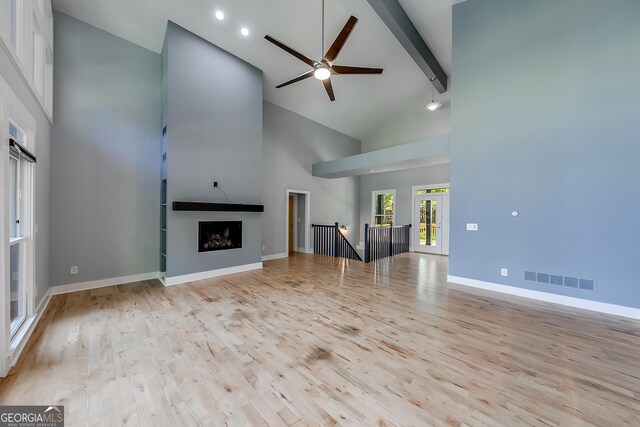 1762 Green Rd, Buford, GA 30518 - unfurnished living room with visible vents, baseboards, beam ceiling, and wood finished floors