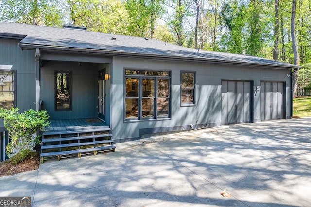 1762 Green Rd, Buford, GA 30518 - back of property with roof with shingles, an attached garage, driveway, and a chimney