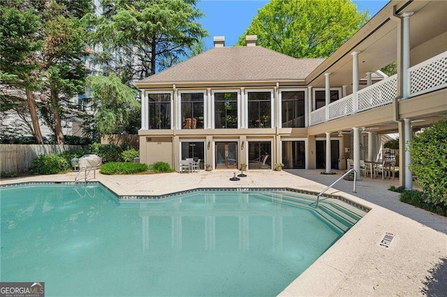 view of pool featuring fence and a patio