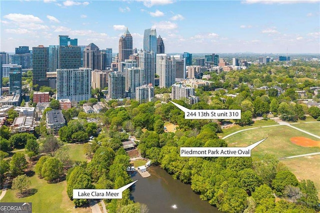aerial view of property and surrounding area with a view of skyline and a large body of water