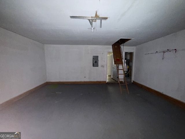 bonus room with finished concrete flooring, baseboards, and electric panel