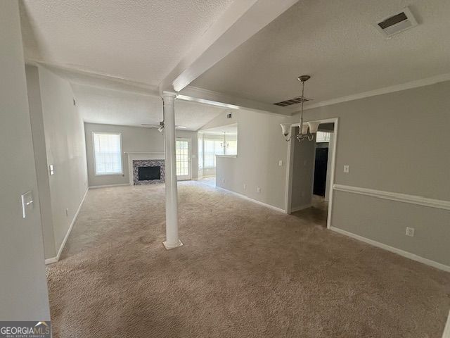 unfurnished living room featuring a chandelier, carpet, visible vents, and a textured ceiling