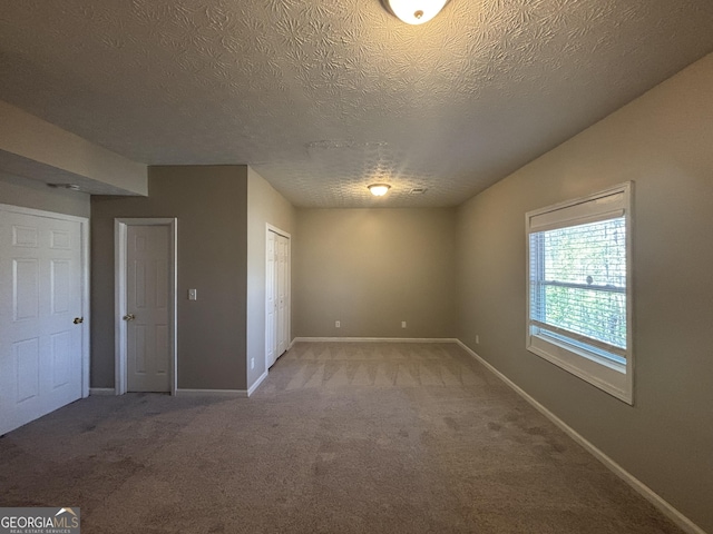 7455 Royal Ct, Riverdale, GA 30296 - empty room featuring light carpet, baseboards, and a textured ceiling