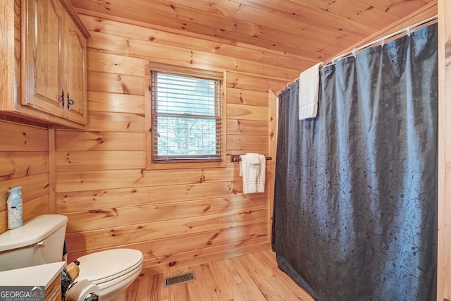 425 Rhonda Ln, Mineral Bluff, GA 30559 - bathroom with toilet, wooden walls, wood finished floors, and a shower with shower curtain