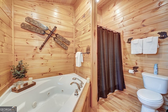 425 Rhonda Ln, Mineral Bluff, GA 30559 - full bathroom featuring wooden walls, toilet, a whirlpool tub, a shower with shower curtain, and wood finished floors