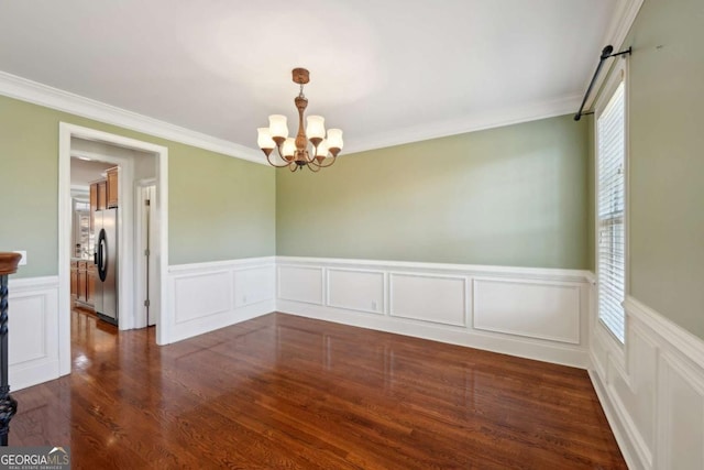 5615 Toccoa Dr, Douglasville, GA 30135 - unfurnished room featuring crown molding, an inviting chandelier, dark wood-style floors, and wainscoting