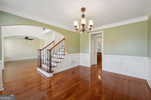 5615 Toccoa Dr, Douglasville, GA 30135 - unfurnished dining area with ceiling fan with notable chandelier, arched walkways, ornamental molding, stairway, and wood finished floors