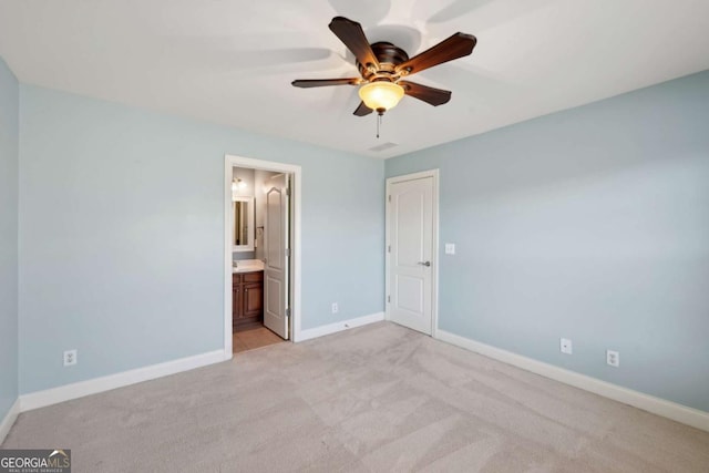 5615 Toccoa Dr, Douglasville, GA 30135 - unfurnished bedroom featuring baseboards, connected bathroom, ceiling fan, and light carpet