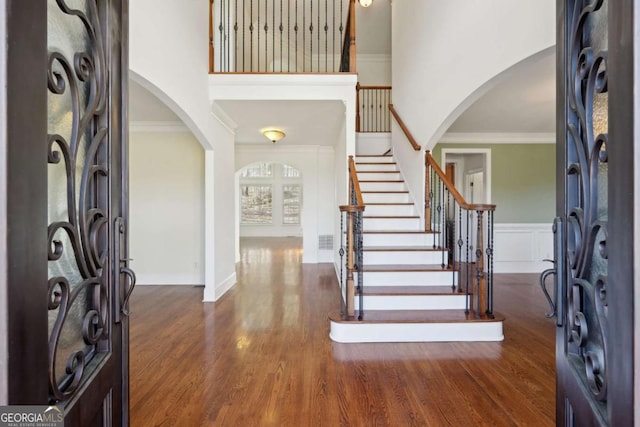 5615 Toccoa Dr, Douglasville, GA 30135 - entryway with arched walkways, a high ceiling, crown molding, and wood finished floors
