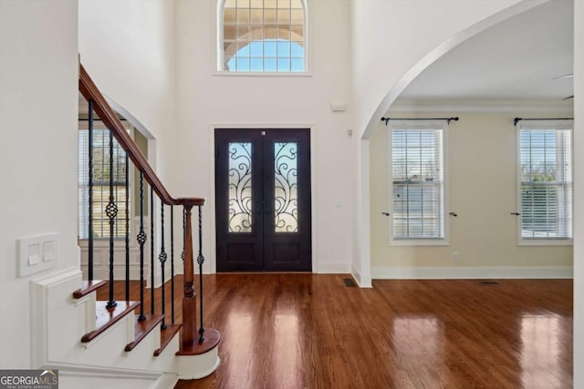 5615 Toccoa Dr, Douglasville, GA 30135 - foyer with arched walkways, wood finished floors, ornamental molding, and stairway