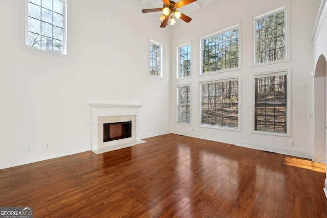 5615 Toccoa Dr, Douglasville, GA 30135 - unfurnished living room with a wealth of natural light, a ceiling fan, a towering ceiling, and wood finished floors