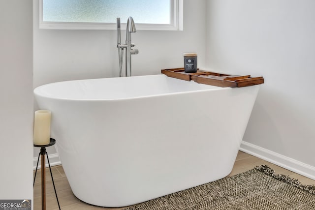 219 Rusty Plow Ln Unit 69, Perry, GA 31069 - room details featuring a sink, baseboards, a soaking tub, and wood finished floors