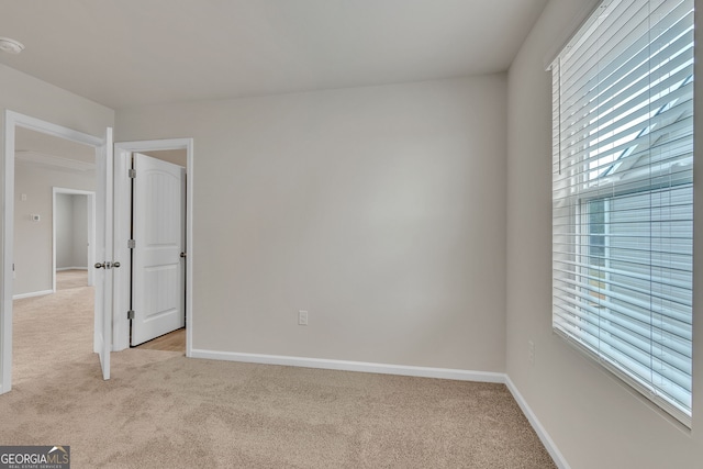 219 Rusty Plow Ln Unit 69, Perry, GA 31069 - unfurnished bedroom with light colored carpet, baseboards, and multiple windows