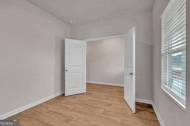219 Rusty Plow Ln Unit 69, Perry, GA 31069 - unfurnished bedroom with baseboards and light wood-style floors