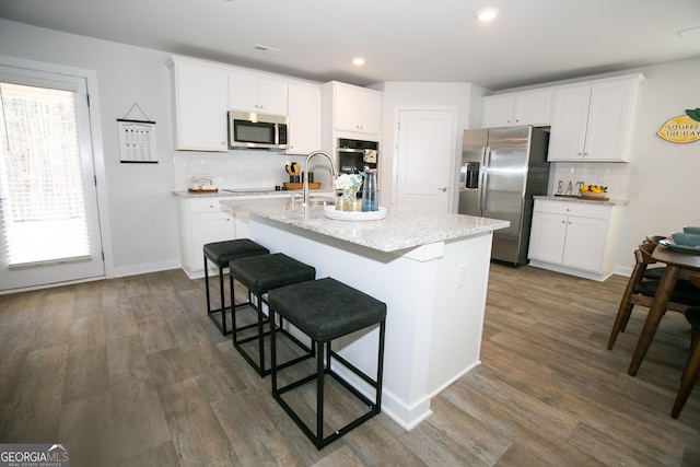 219 Rusty Plow Ln Unit 69, Perry, GA 31069 - kitchen with a sink, white cabinetry, a center island with sink, dark wood-type flooring, and stainless steel appliances