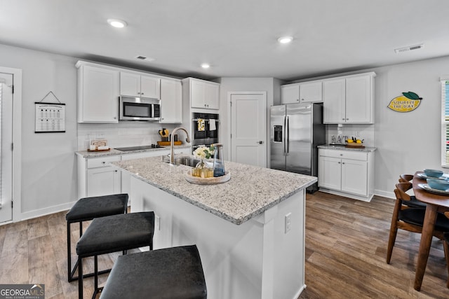219 Rusty Plow Ln Unit 69, Perry, GA 31069 - kitchen with white cabinetry, visible vents, a sink, stainless steel appliances, and dark wood-style floors