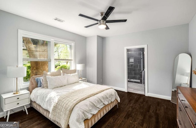 bedroom featuring dark wood-style flooring, multiple windows, baseboards, and visible vents