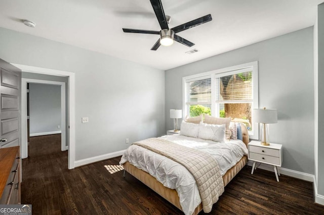 bedroom with wood finished floors, ceiling fan, baseboards, and visible vents