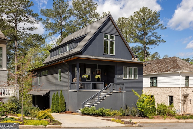 view of front of property with a porch and stairway