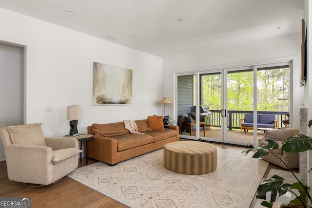 living room with visible vents and wood finished floors
