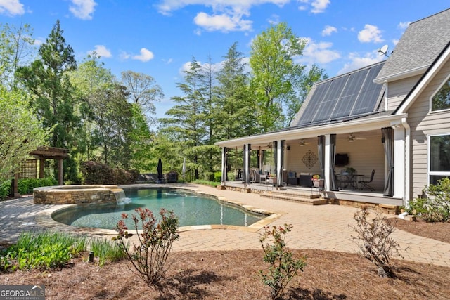 view of swimming pool with a patio area, ceiling fan, and a pool with connected hot tub
