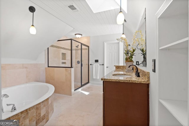 bathroom with a bath, vanity, visible vents, a stall shower, and lofted ceiling with skylight