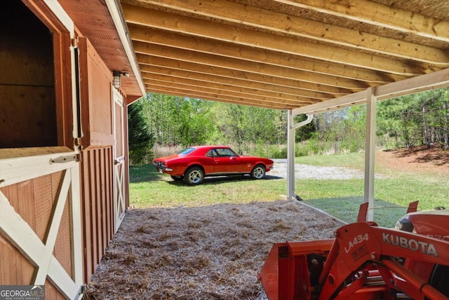 view of yard with a carport and an outdoor structure