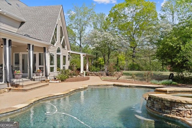 view of pool featuring a pool with connected hot tub and a patio