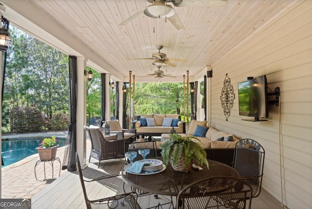 wooden deck featuring an outdoor pool, outdoor lounge area, and ceiling fan