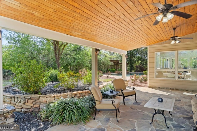 view of patio featuring an outdoor pool, fence, and a ceiling fan