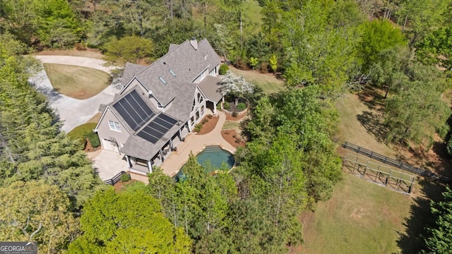 birds eye view of property featuring a wooded view