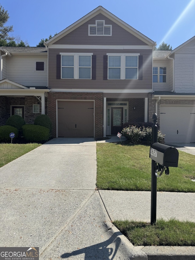 3627 Mcclaren Way, Lawrenceville, GA 30044 - view of property featuring concrete driveway, a front yard, brick siding, and an attached garage