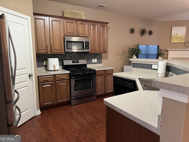 3627 Mcclaren Way, Lawrenceville, GA 30044 - kitchen with visible vents, dark wood-style flooring, light countertops, stainless steel appliances, and decorative backsplash