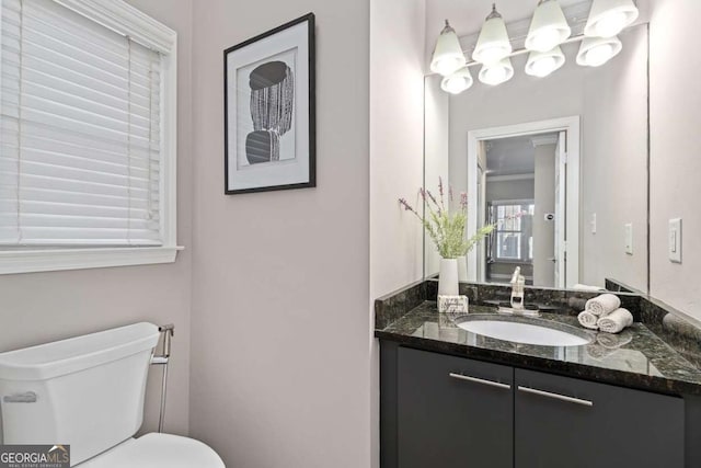 bathroom with toilet and vanity