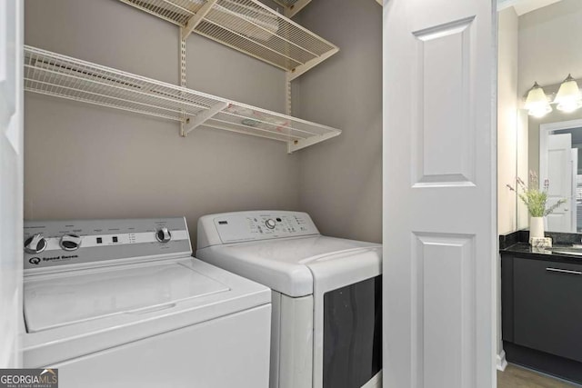 clothes washing area featuring washing machine and dryer and laundry area