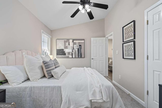 bedroom featuring carpet, baseboards, vaulted ceiling, and a ceiling fan