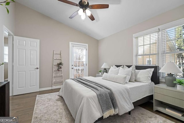 bedroom featuring access to outside, a ceiling fan, vaulted ceiling, wood finished floors, and baseboards