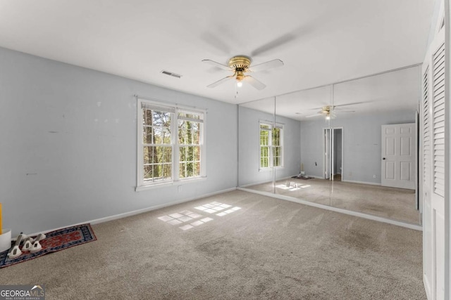6500 Gaines Ferry Rd, Flowery Branch, GA 30542 - spare room with visible vents, carpet floors, baseboards, and ceiling fan