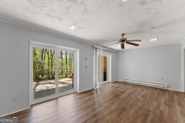 6500 Gaines Ferry Rd, Flowery Branch, GA 30542 - spare room with a baseboard radiator, a ceiling fan, wood finished floors, and a textured ceiling