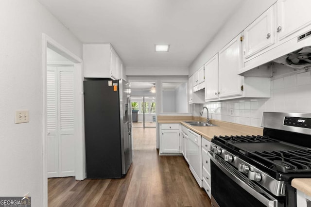 6500 Gaines Ferry Rd, Flowery Branch, GA 30542 - kitchen featuring white cabinetry, under cabinet range hood, dark wood finished floors, stainless steel appliances, and a sink