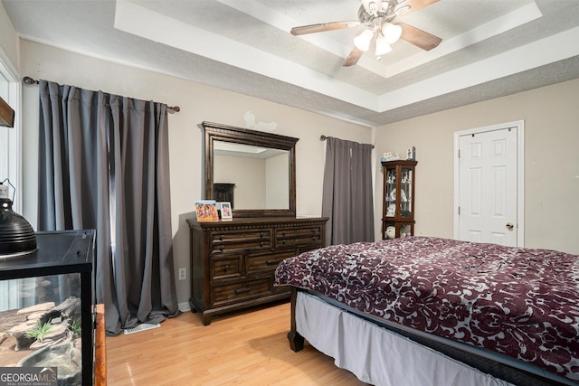 130 Manning Mill Rd NW, Adairsville, GA 30103 - bedroom featuring a raised ceiling, light wood-style floors, and a ceiling fan