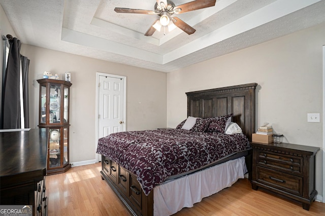 130 Manning Mill Rd NW, Adairsville, GA 30103 - bedroom with light wood-style floors, a tray ceiling, ceiling fan, and baseboards