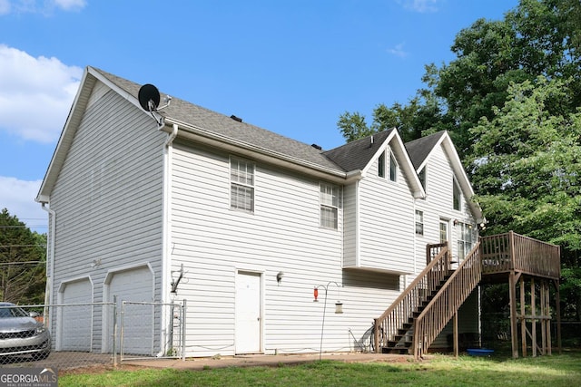 130 Manning Mill Rd NW, Adairsville, GA 30103 - back of house with stairs, an attached garage, a wooden deck, fence, and driveway