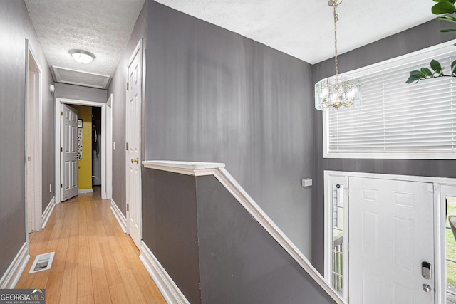 130 Manning Mill Rd NW, Adairsville, GA 30103 - entryway featuring light wood finished floors, a textured ceiling, baseboards, and a chandelier