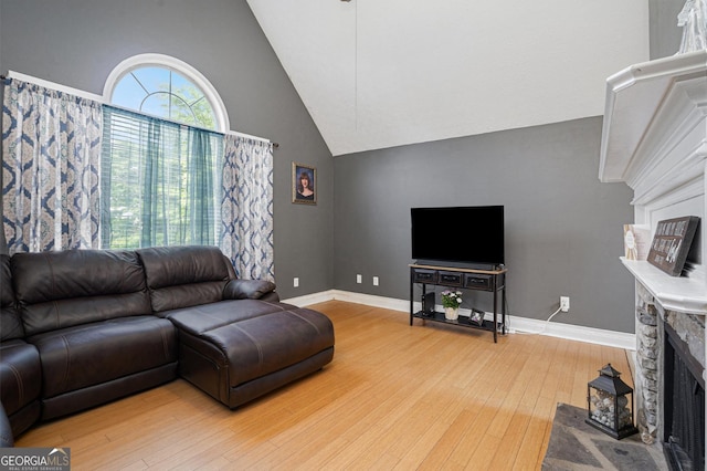 130 Manning Mill Rd NW, Adairsville, GA 30103 - living room with wood-type flooring, a fireplace, high vaulted ceiling, and baseboards
