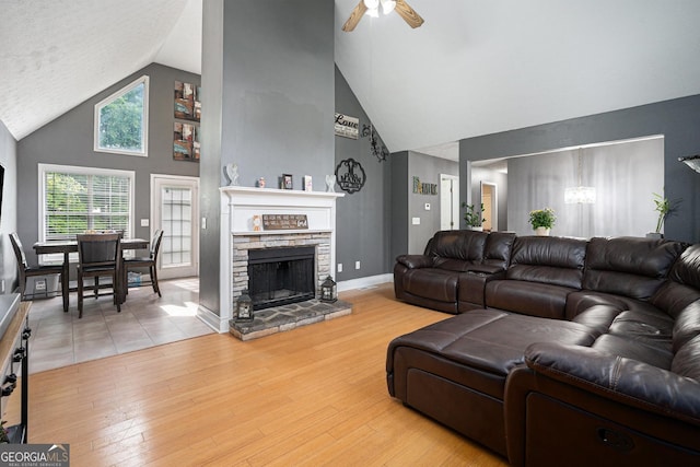 130 Manning Mill Rd NW, Adairsville, GA 30103 - living area with high vaulted ceiling, a chandelier, ceiling fan, wood finished floors, and a stone fireplace